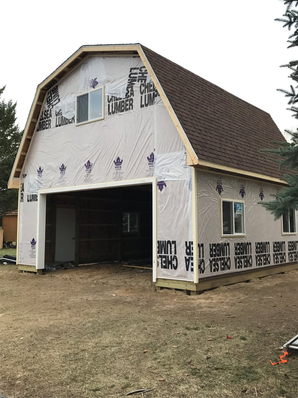 Step #3 of building a pole barn, put on the roofing, house wrap, windows and doors.